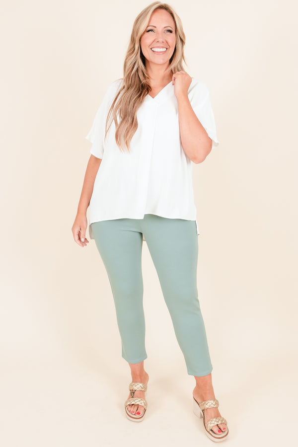 Plus Size off white flowy short sleeve top with a V-neckline and light polyester fabric.