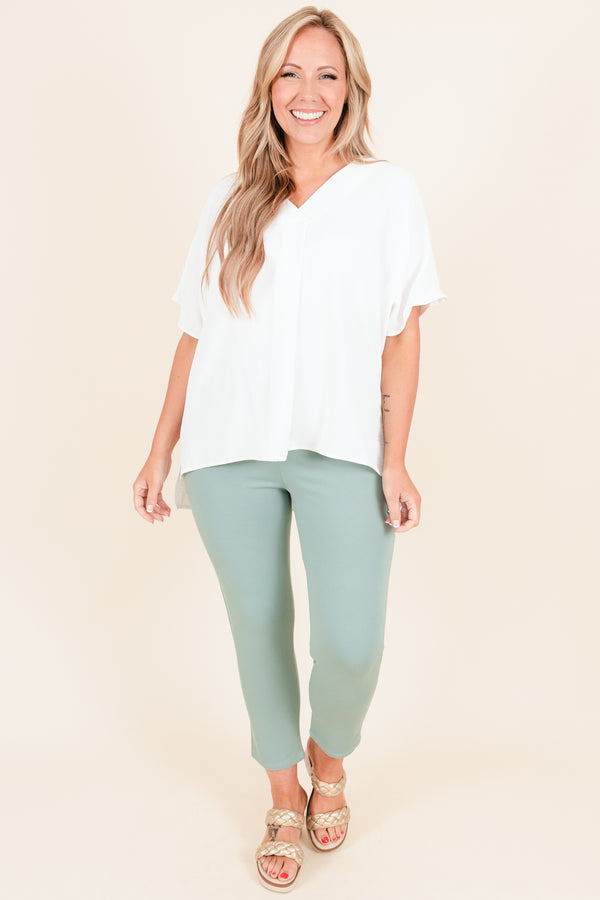 Plus Size off white flowy short sleeve top with a V-neckline and light polyester fabric.