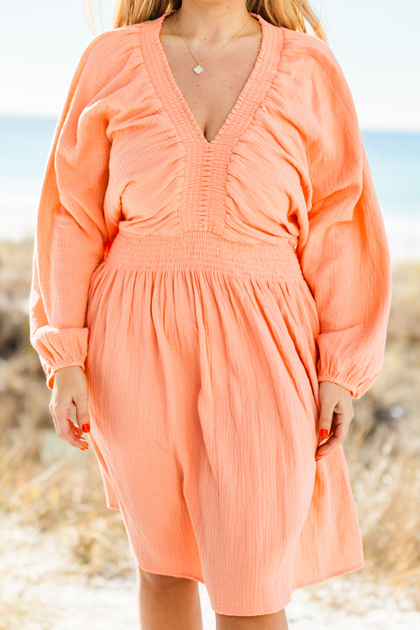 Plus Size coral v-neck dress with billowy long sleeves, smocked waist, and textured cotton fabric.