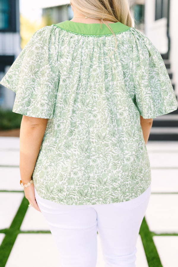 Chic Soul plus size clothing, green floral top with bell sleeves and a v-neckline that it outlined in green fabric 