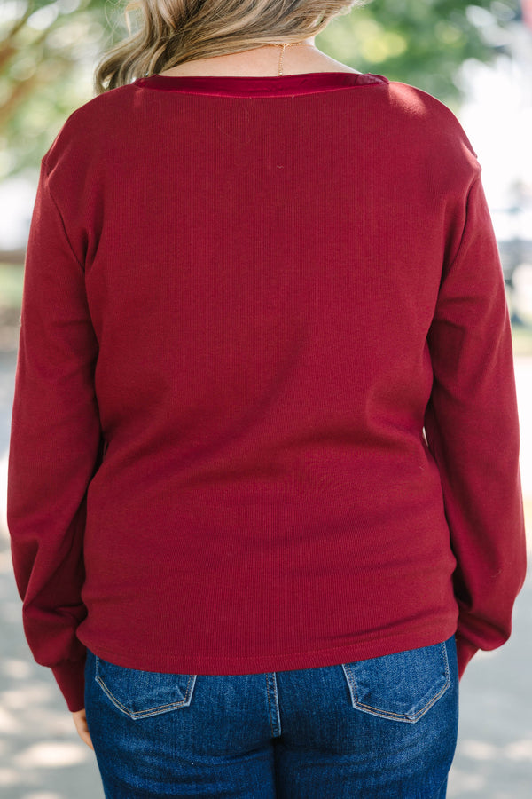 Plus Size burgundy long sleeve top with a ribbed texture and a satin-trimmed v-neckline.