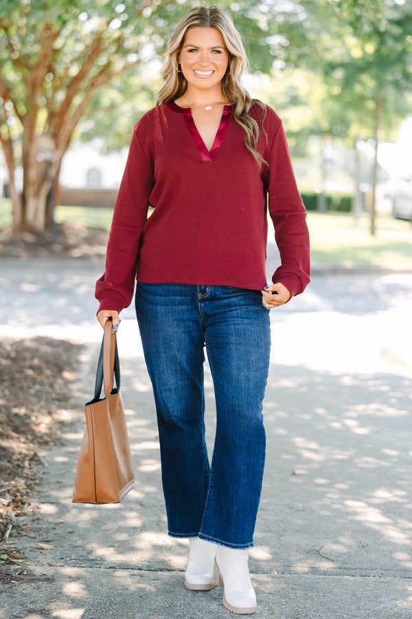 Plus Size burgundy long sleeve top with a ribbed texture and a satin-trimmed v-neckline.