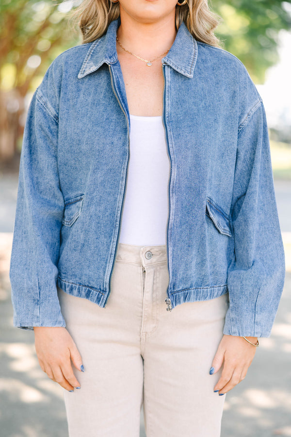 Plus size denim jacket with a zip-up front, collar, and relaxed fit.