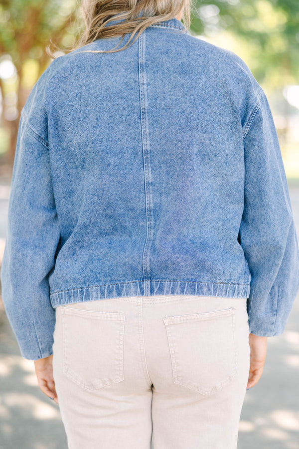 Plus size denim jacket with a zip-up front, collar, and relaxed fit.