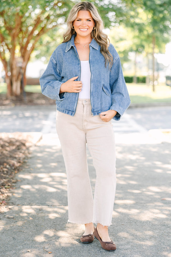 Plus size denim jacket with a zip-up front, collar, and relaxed fit.