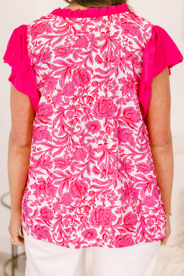Plus Size pink floral print top with flutter sleeves and a ruffled V-neckline.