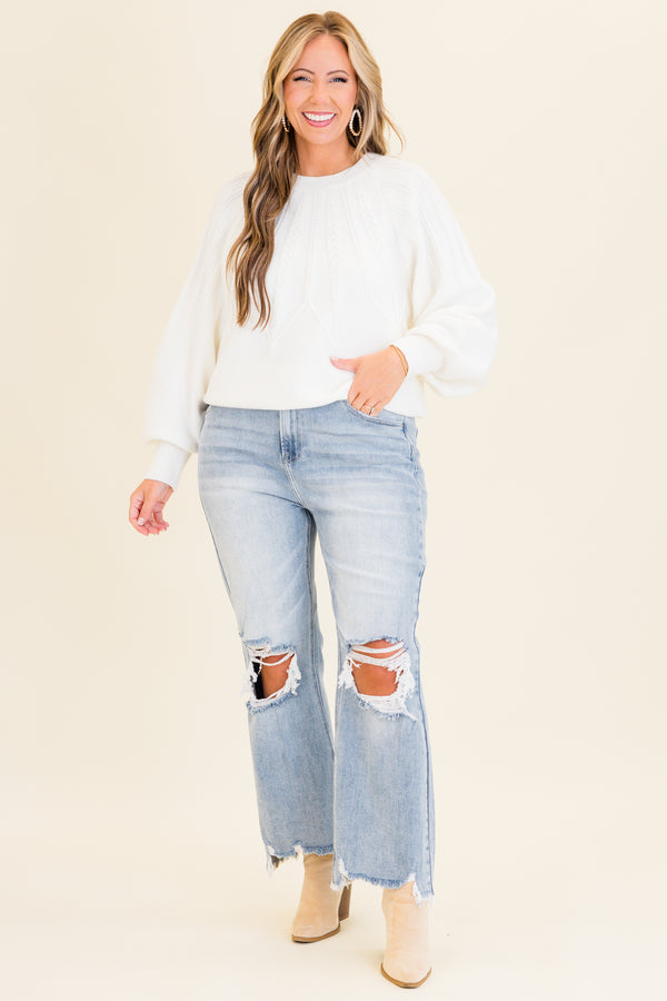 Chic Soul plus size clothing, light wash denim jeans with slight flare at the bottom with holes and distressing on knees with raw distressed hem at the bottom