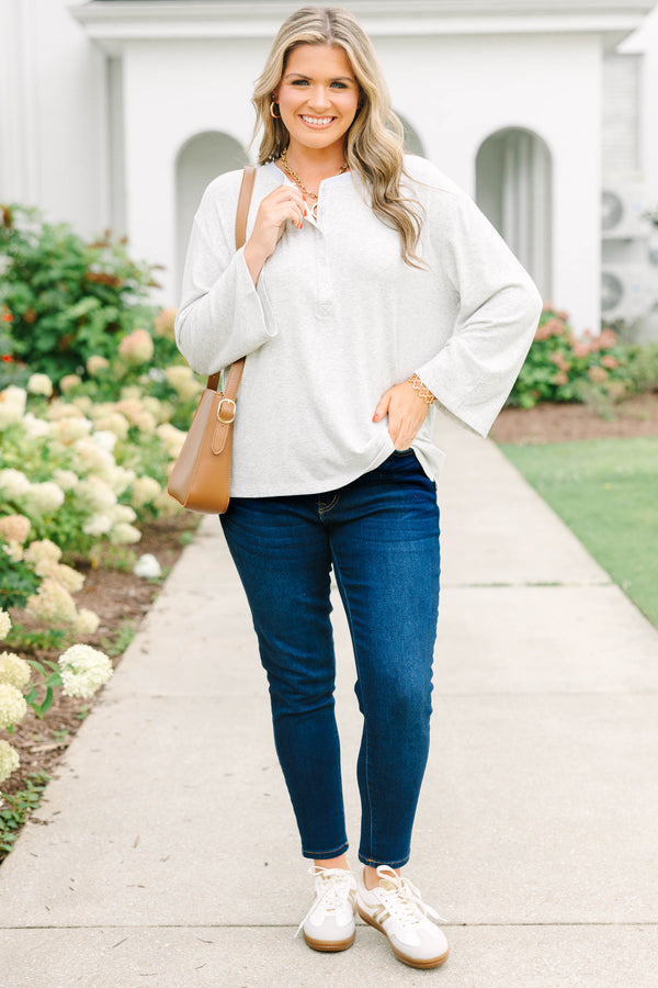 Heather grey oversized knit henley top with a button placket and dropped shoulders.