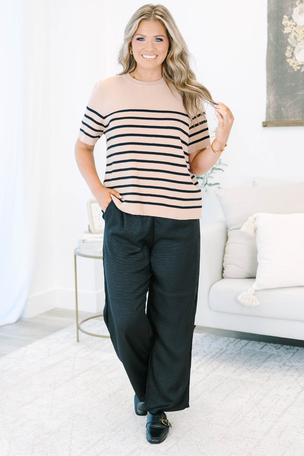 Plus size black wide-leg pants with a comfortable elastic waist and flowy, textured fabric.