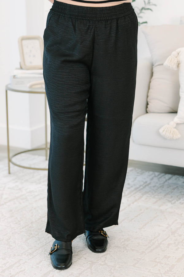 Plus size black wide-leg pants with a comfortable elastic waist and flowy, textured fabric.