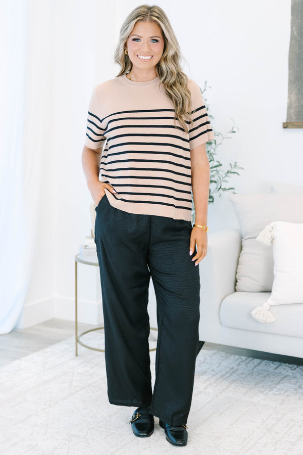 Plus size black wide-leg pants with a comfortable elastic waist and flowy, textured fabric.