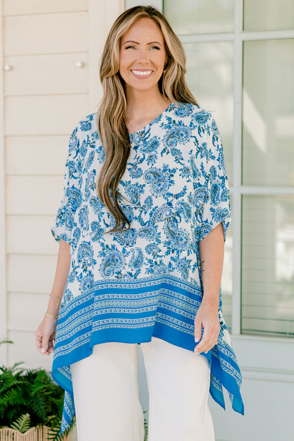 Plus Size blue paisley tunic with contrast striped hem and loose, short sleeves.