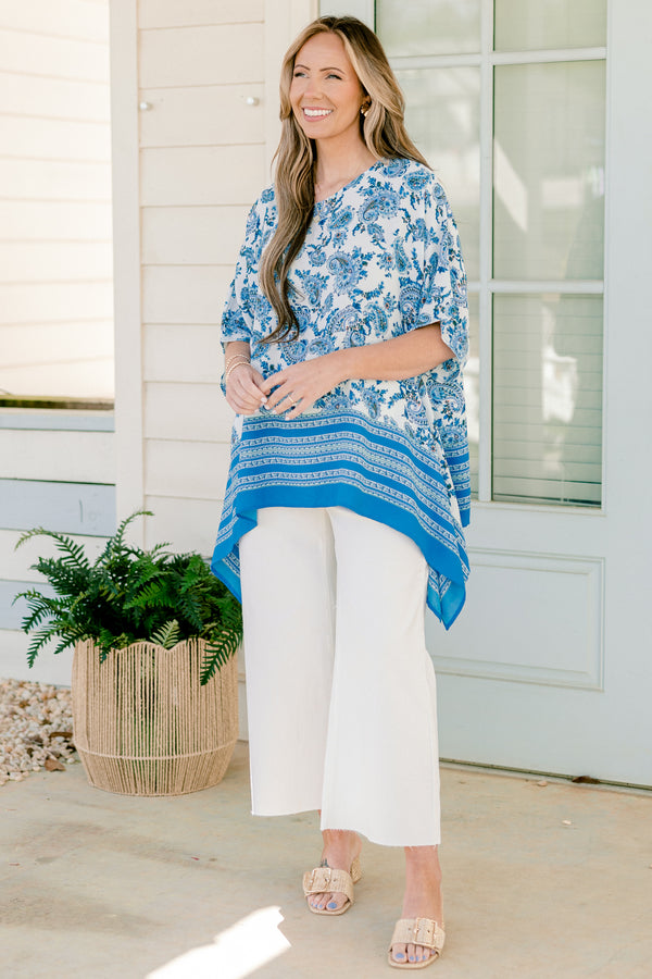 Plus Size blue paisley tunic with contrast striped hem and loose, short sleeves.