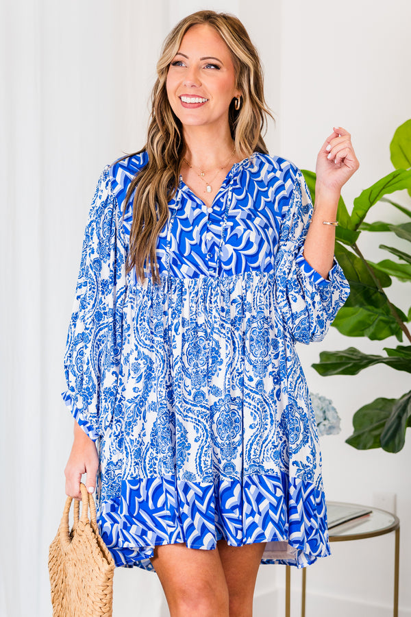 Chic Soul plus size clothing, royal blue mini dress with three quarter length sleeves with tiered pattern detail abstract and paisley print with v cutout on neckline with tie detail