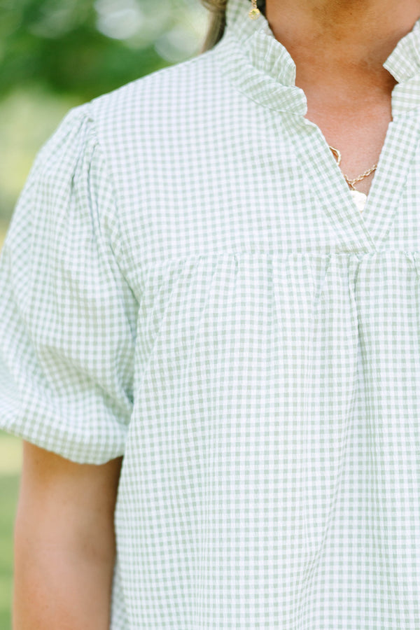 Plus Size green and white gingham top with puff sleeves, a ruffled collar, and a split neckline.