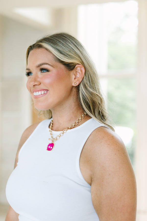 Plus Size gold chain necklace with a large fuchsia square pendant and matching gold stud earrings.