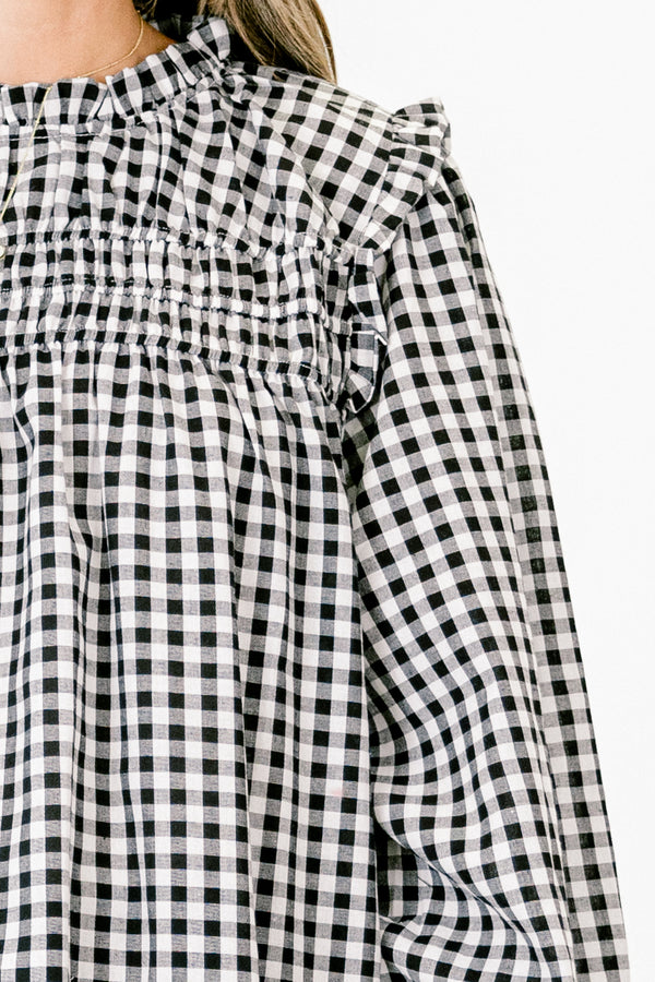 Chic Soul Plus size clothing, Black and white gingham top with long bubble sleeves that have ruffle detail on the ends of the sleeves as well as on the top of the shoulders 
