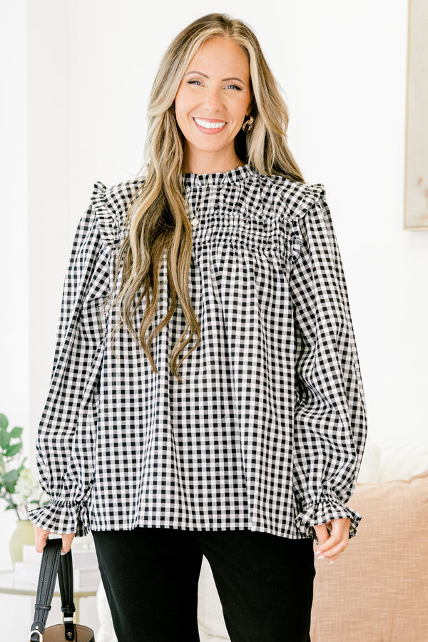 Chic Soul Plus size clothing, Black and white gingham top with long bubble sleeves that have ruffle detail on the ends of the sleeves as well as on the top of the shoulders 
