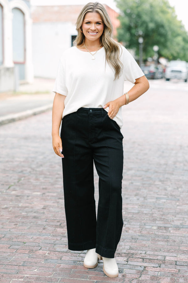Plus Size black high-rise wide-leg jeans with front pintuck detailing and a relaxed fit.