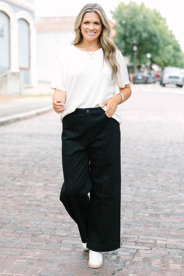 Plus Size black high-rise wide-leg jeans with front pintuck detailing and a relaxed fit.