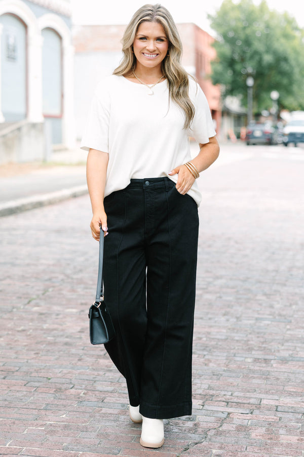 Plus Size black high-rise wide-leg jeans with front pintuck detailing and a relaxed fit.