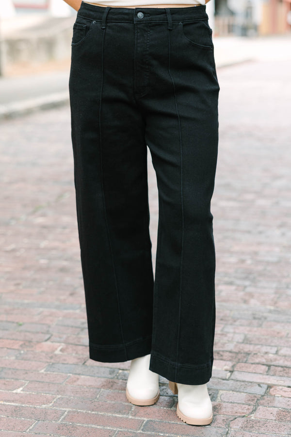 Plus Size black high-rise wide-leg jeans with front pintuck detailing and a relaxed fit.