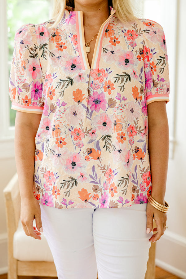 Chic Soul Plus size clothing, coral and peach blouse with a floral pattern and bubble sleeves that have a striped cuff at the end of the sleeves and along the v-neck
