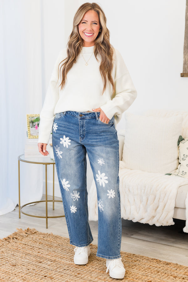 Chic Soul plus size clothing, mid-waisted medium wash denim mom jeans with white flower decals scattered along the front of the jeans