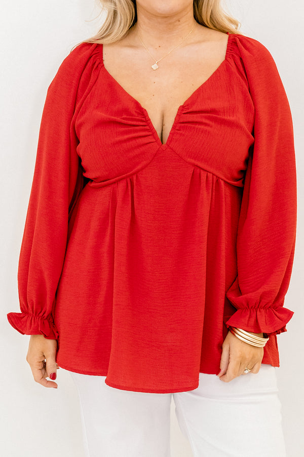 Plus Size red v-neck top with elastic balloon sleeves and a smocked back in a textured fabric.