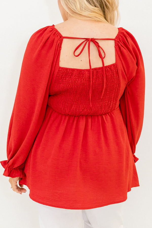 Plus Size red v-neck top with elastic balloon sleeves and a smocked back in a textured fabric.