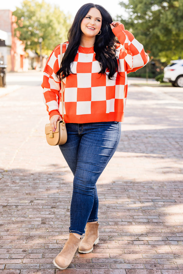 long-sleeve orange and cream checkered sweater with crew neckline and subtly distressed stitching
