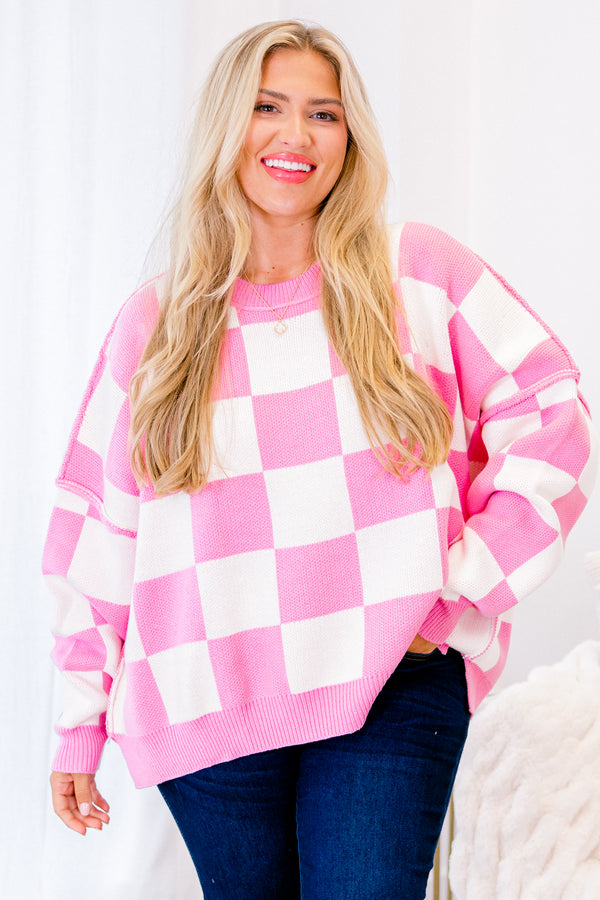 long-sleeve pink and cream checkered sweater with crew neckline and subtly distressed stitching 