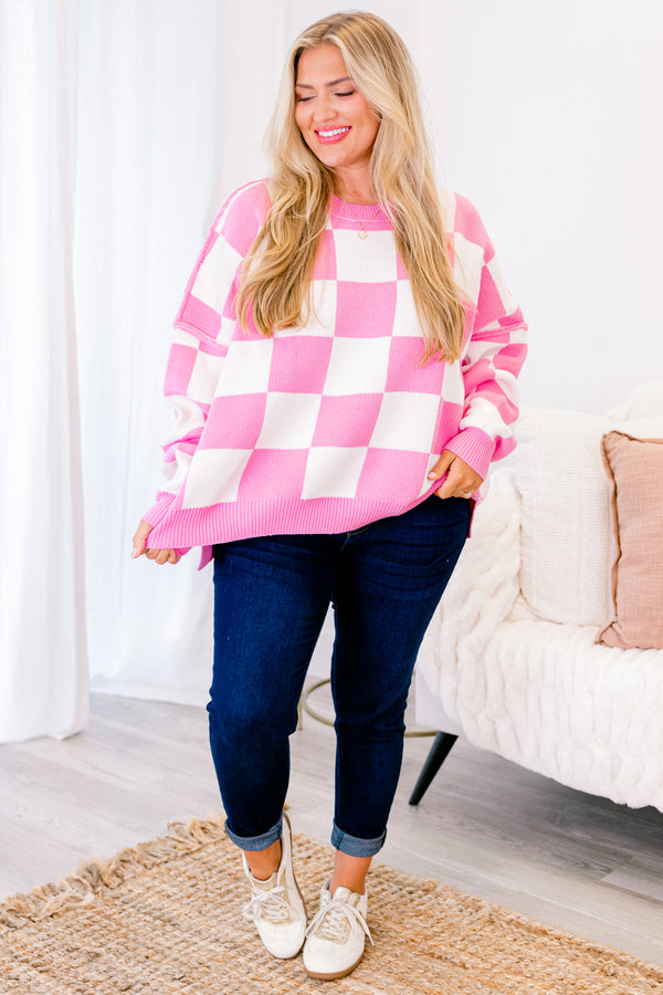 long-sleeve pink and cream checkered sweater with crew neckline and subtly distressed stitching 