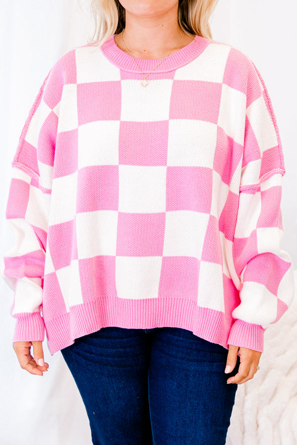 long-sleeve pink and cream checkered sweater with crew neckline and subtly distressed stitching 