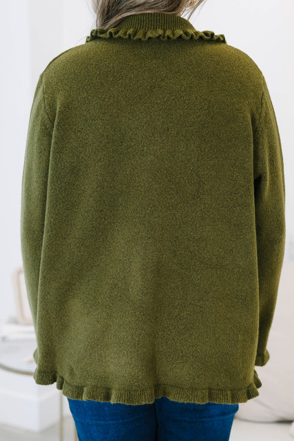 Plus size olive green cardigan with a ruffled collar, pearl buttons, and a flowy, relaxed fit.