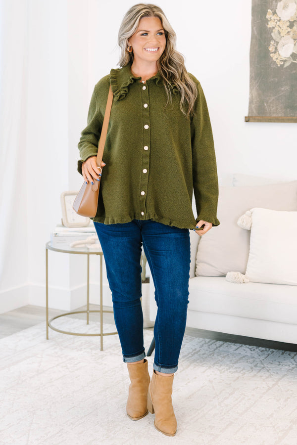 Plus size olive green cardigan with a ruffled collar, pearl buttons, and a flowy, relaxed fit.
