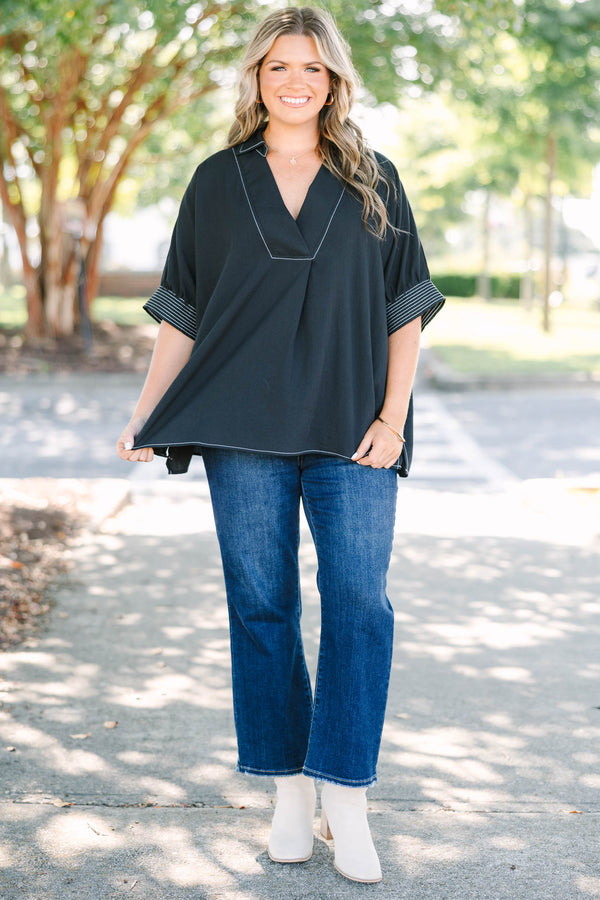 Plus Size black v-neck top with white contrast stitching on the neckline, cuffs, and hem.