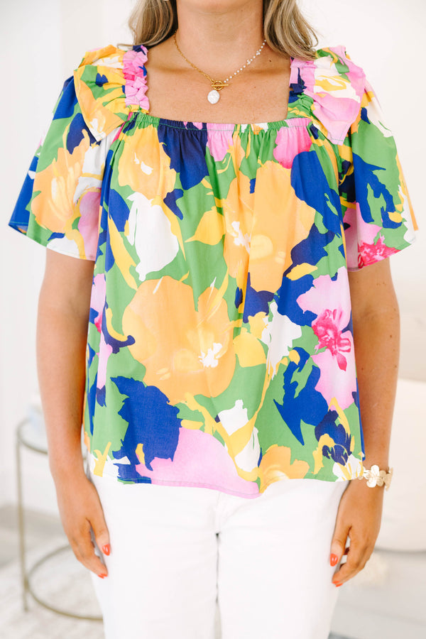 Plus Size green blouse with a bold floral print, square neckline, and ruffled short sleeves.