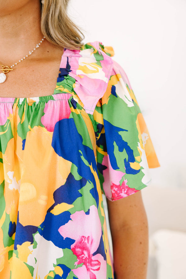 Plus Size green blouse with a bold floral print, square neckline, and ruffled short sleeves.