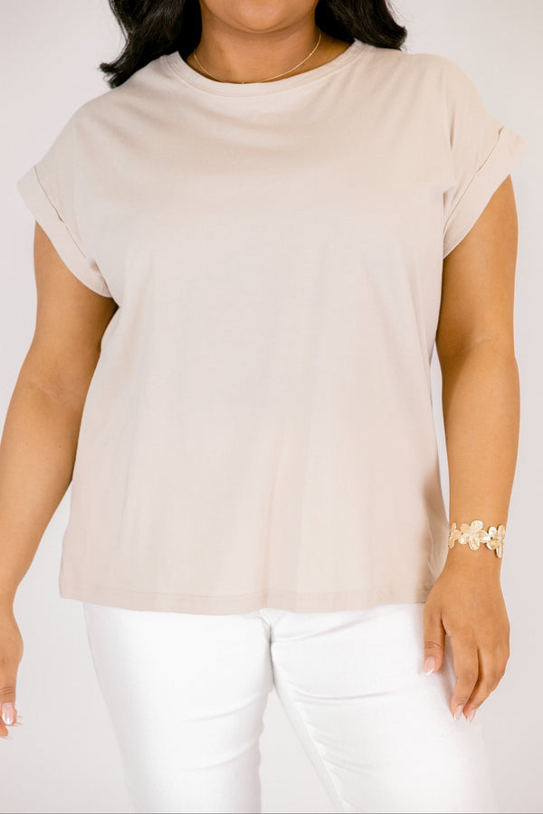 Plus Size sand beige 100% cotton crew neck tee with cuffed short sleeves and white pants.
