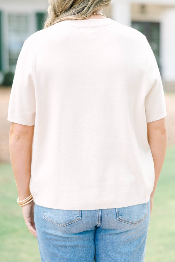 Plus Size light taupe short sleeve knit sweater with a crew neckline and ribbed trim.