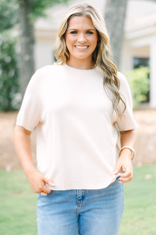 Plus Size light taupe short sleeve knit sweater with a crew neckline and ribbed trim.