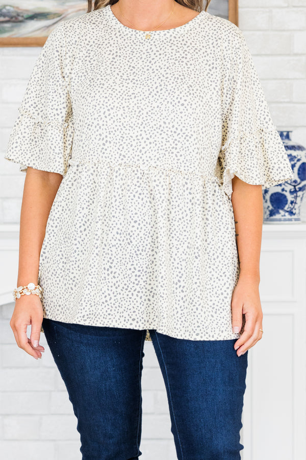 Chic Soul plus size clothing, ivory-grey short sleeve babydoll top with ruffle detail on sleeves and round neckline with ruffle along waist with small dotted print