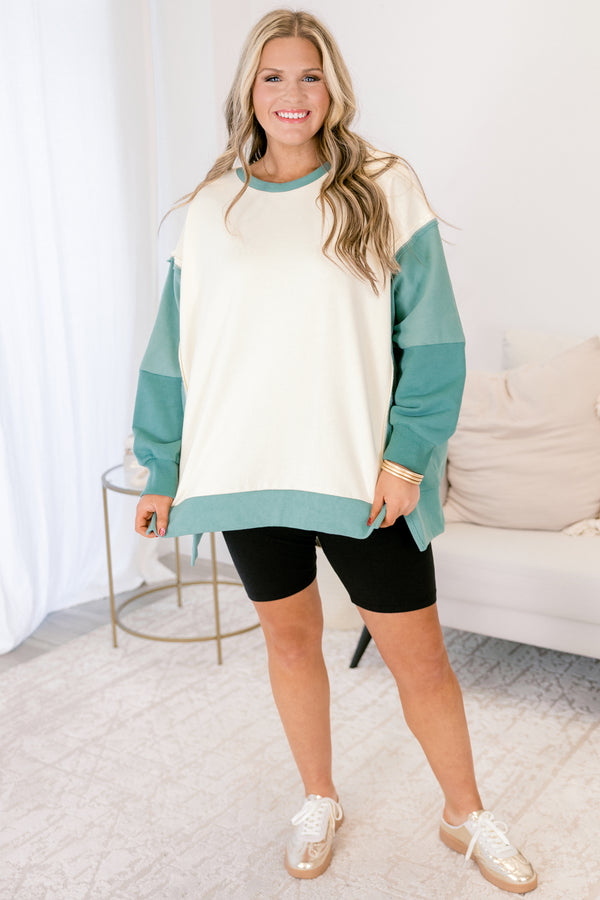 Chic Soul plus size clothing, cream long sleeve pullover over, with two different green accents on the sleeves as well as going along the sides and bottom of the pullover and across the neckline