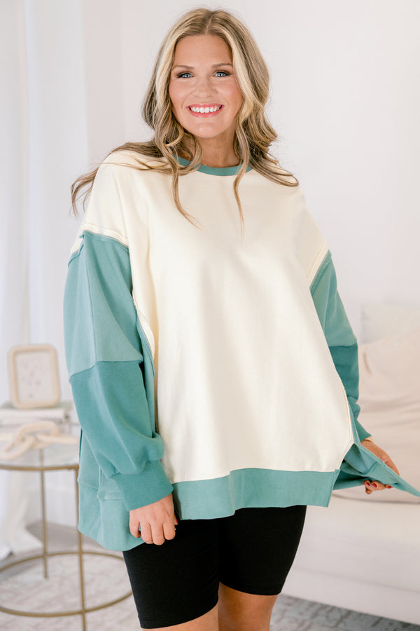 Chic Soul plus size clothing, cream long sleeve pullover over, with two different green accents on the sleeves as well as going along the sides and bottom of the pullover and across the neckline