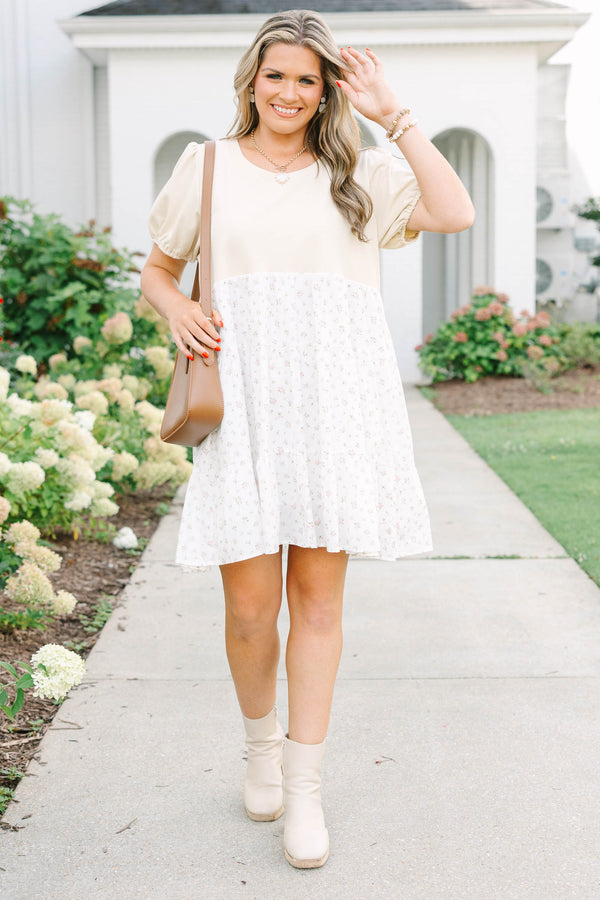 Plus size cream dress with bubble sleeves and a tiered floral skirt, featuring a flowy fit.