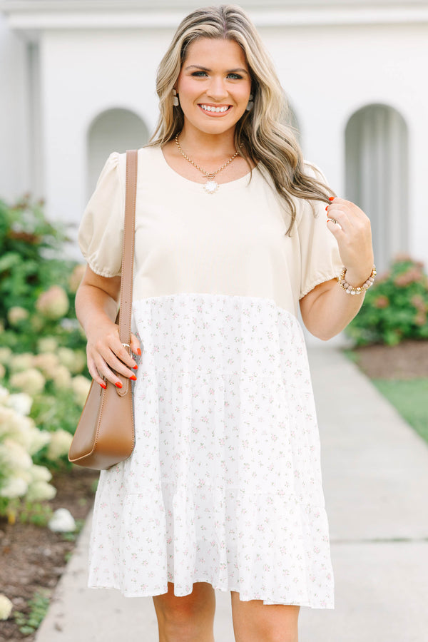 Plus size cream dress with bubble sleeves and a tiered floral skirt, featuring a flowy fit.