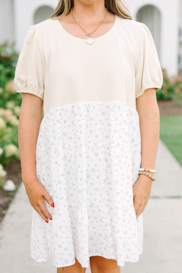 Plus size cream dress with bubble sleeves and a tiered floral skirt, featuring a flowy fit.