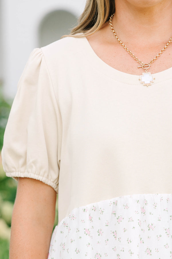 Plus size cream dress with bubble sleeves and a tiered floral skirt, featuring a flowy fit.