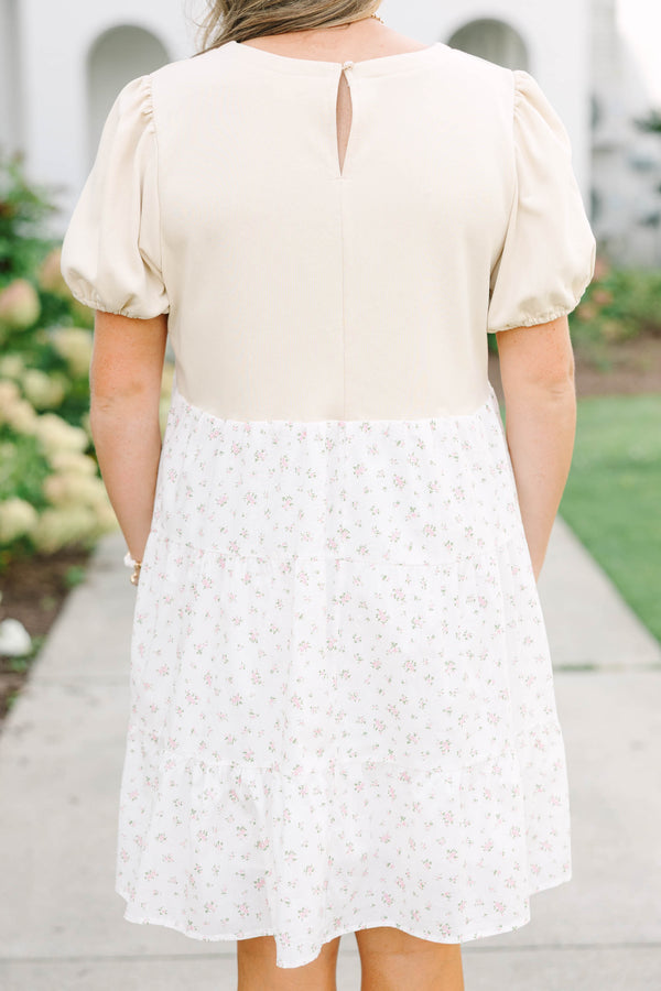 Plus size cream dress with bubble sleeves and a tiered floral skirt, featuring a flowy fit.